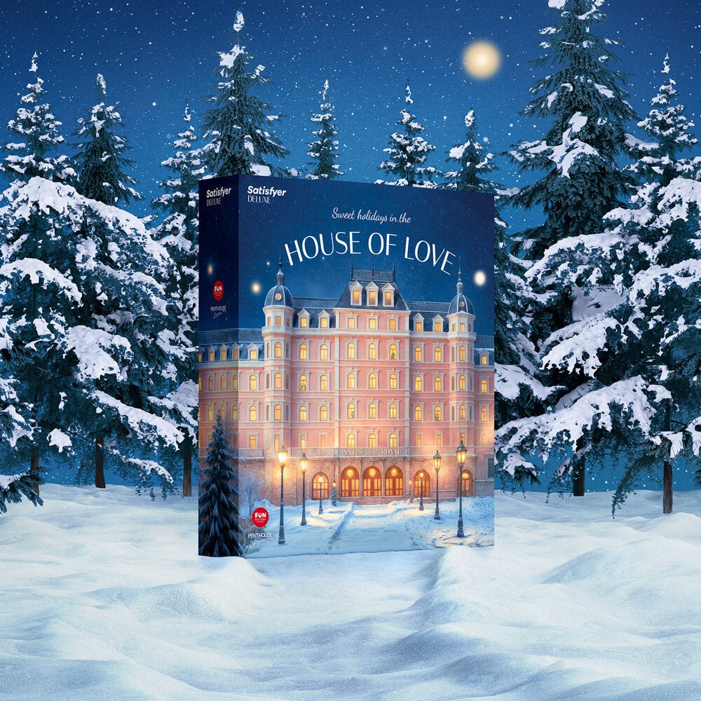 Donkerblauwe Satisfyer Deluxe Adventskalender 2025 doos recht van voren met gouden sterren en sneeuwachtige achtergrond