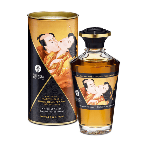 Shunga Caramel Kisses verwarmende olie 100 ml met fles en goudzwarte verpakking op witte achtergrond