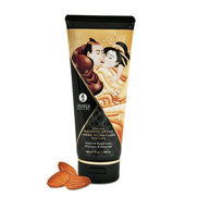 Shunga Amandelzoetheid massagecrème 200 ml in tube met warm oranje crèmedetail ernaast