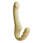 Beige Odes Within strapless strap-on vibrator in zijaanzicht met dubbele gebogen vorm en subtiele groeflijnen.