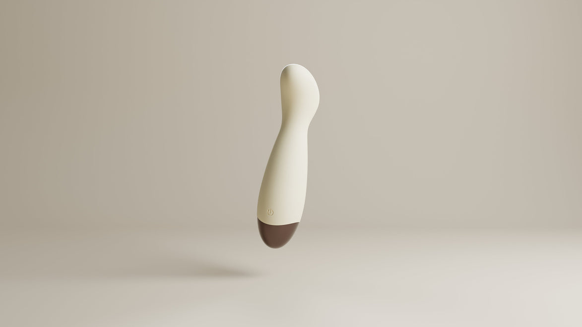 Odes Ease Mini Wand Vibrator in beige, schuin zwevend met afgeronde kop, powerknop en bruine onderzijde