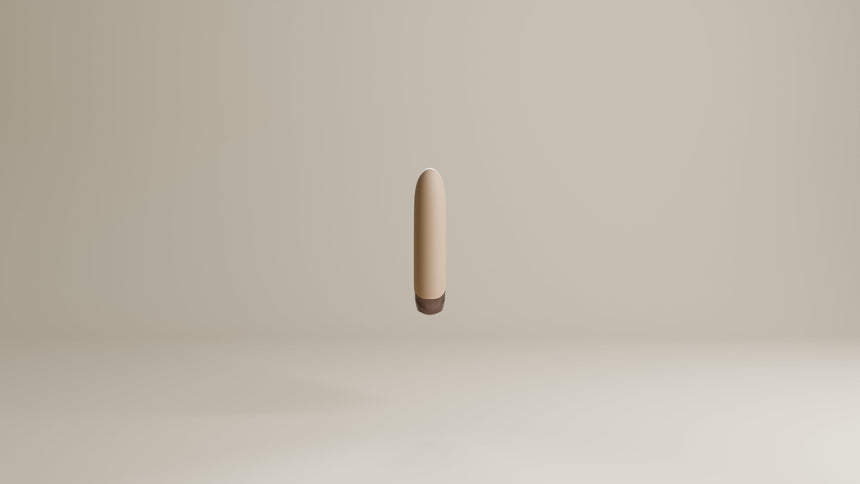 Odes Intima Mini Bullet Vibrator in beige, zwevend frontaal gefotografeerd met donker afgerond uiteinde