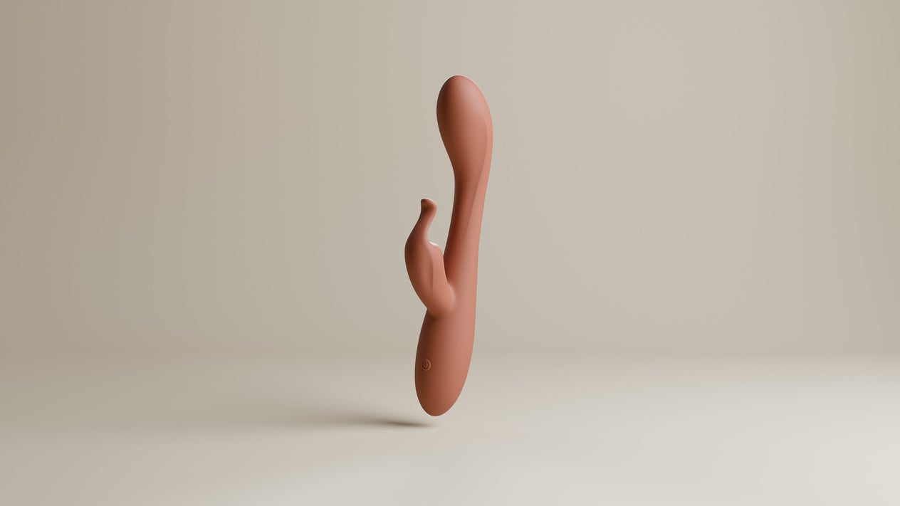 Odes Lustra Tarzan vibrator in terracotta, staand in studio met gebogen vorm en kleine stimulator