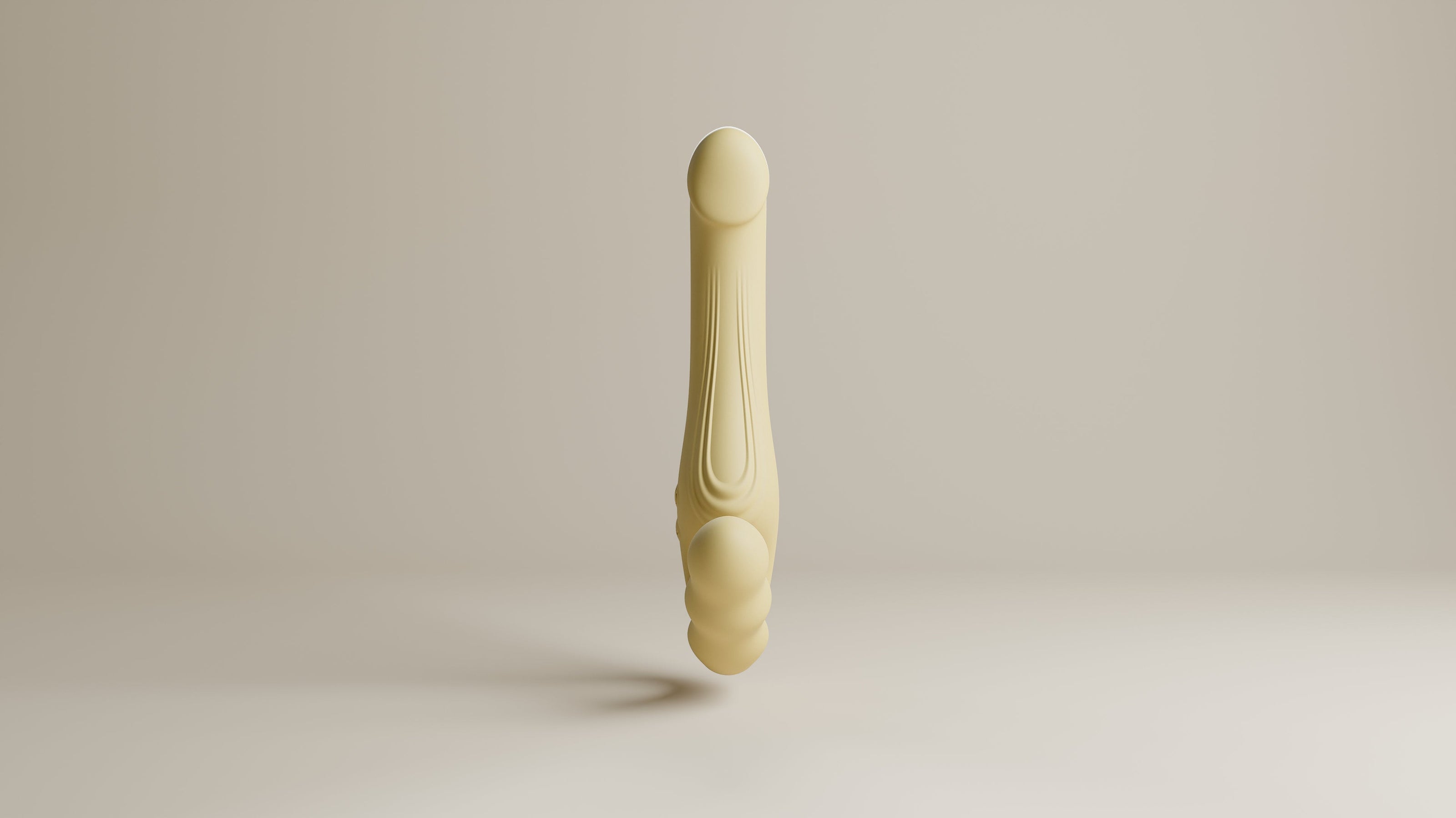Odes Within vibrator in beige, frontaal gefotografeerd met lang gebogen ontwerp en subtiele ribdetails